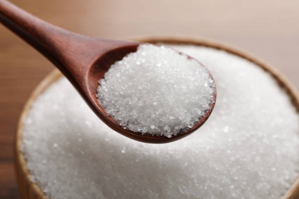 istock Spoon with granulated sugar over bowl, closeup 1468537364