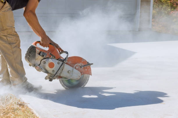 istock Working with a diamond bladed cut off saw to cut off concrete paving slabs for a sidewalk, a construction worker cuts the slabs for the sidewalk. 1468538428