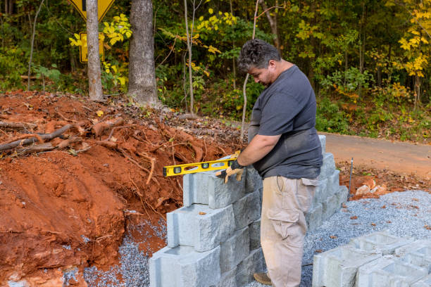 istock A contractor installed a concrete block after leveling walls on part new retaining wall construction project. 1468538450