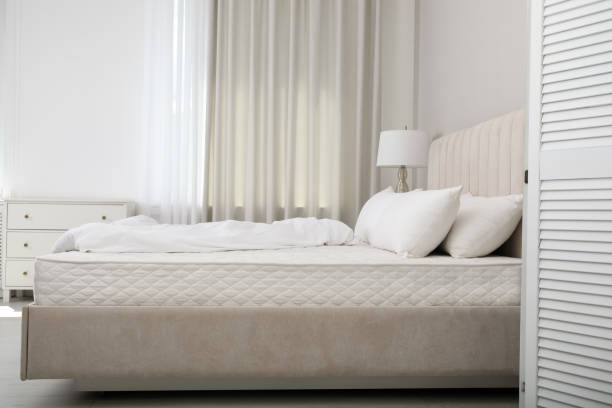 istock Comfortable bed with soft white mattress, blanket and pillows indoors 1468539942