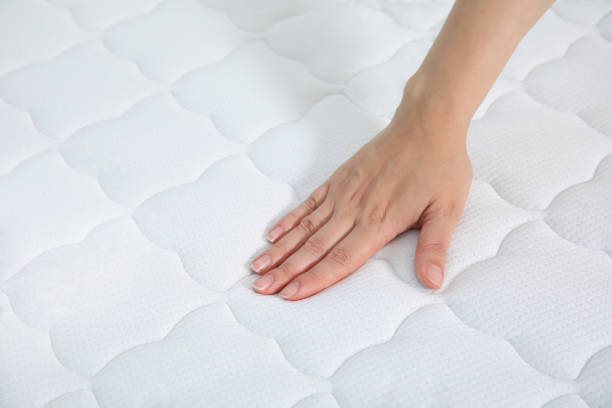 istock Woman touching soft white mattress, closeup view 1468540003
