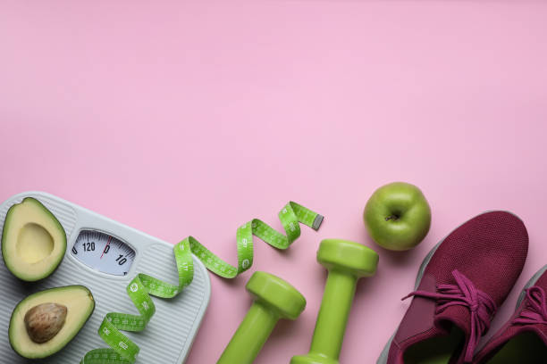 istock Flat lay composition with scales and measuring tape on pink background, space for text 1468540449