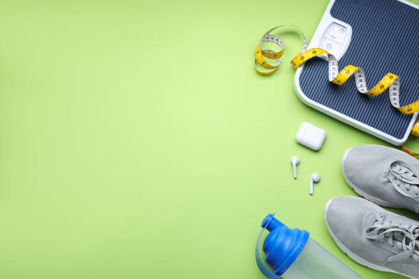 istock Flat lay composition with scales and measuring tape on green background, space for text 1468540584