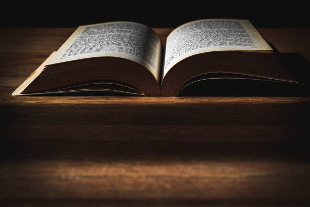 istock there was a book on a wooden table in a poorly-lit room. 1468540766