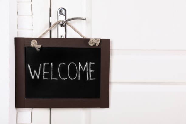 istock Small chalkboard with word Welcome hanging on door handle, space for text 1468542580