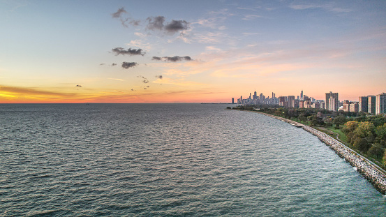 Aerial view of the water's edge of Lake Michigan, leading into the city and skyline