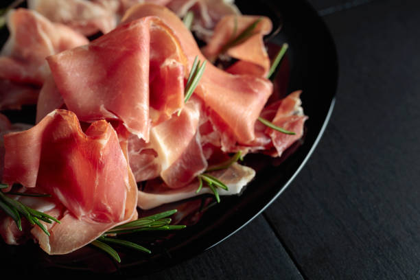 istock Italian prosciutto or Spanish jamon with rosemary. 1468545645