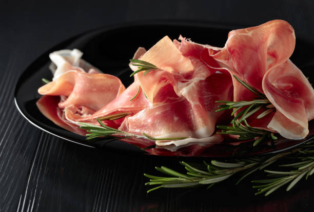 istock Italian prosciutto or Spanish jamon with rosemary. 1468545663