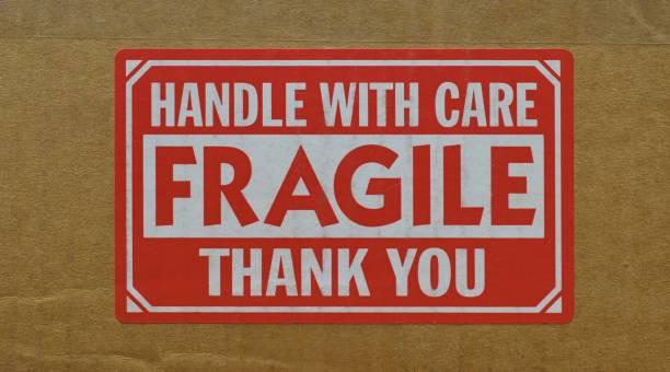 istock Handle with care sticker attached to the side of a cardboard box. 1468546817