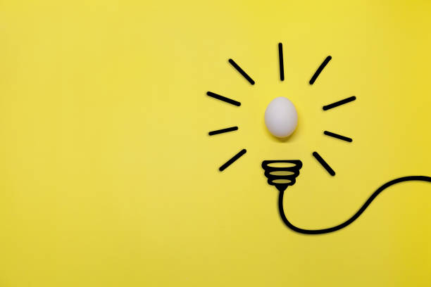 istock Idea symbol in the form of a painted light bulb with egg inside on a yellow background. Easter time 1468550957