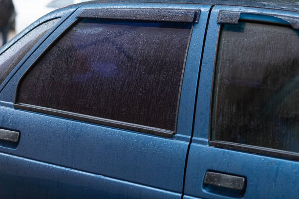 istock Tinted rear window of a car with raindrops 1468551097