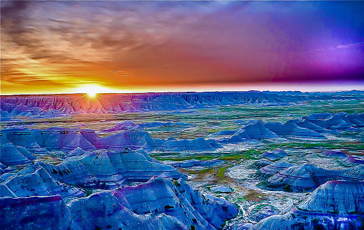 Vivid sunrise over Badlands National Park evokes an atmosphere of mystery and peace. Portrays an unearthly landscape as if another planet.