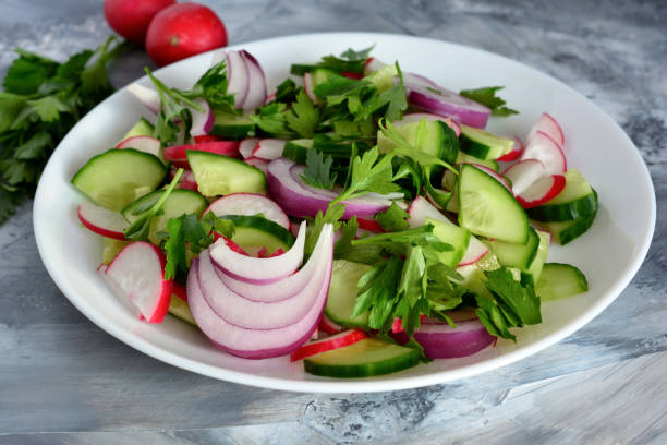 istock vegetable salad with radish and cucumber isolated on white plate, macro 1468556059