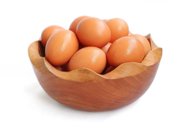 istock Fresh home grown eggs in wooden bowl isolated on white background 1468557042