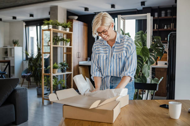istock Young woman unboxing a delivery package 1468558022