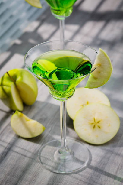 istock Appletini cocktail, apple martini cocktail garnished with green apple. Martini alcoholic cocktail or non-alcoholic mocktail. Martinis. 1468559294