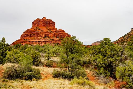 This is a landscape photograph of the Bell Rock Vortex in Sedona, Arizona on an overcast spring day.