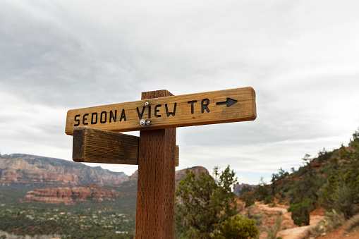 This is a photograph of a trail marker the Airport Loop hiking trail in the scenic landscape in Sedona, Arizona in spring time.