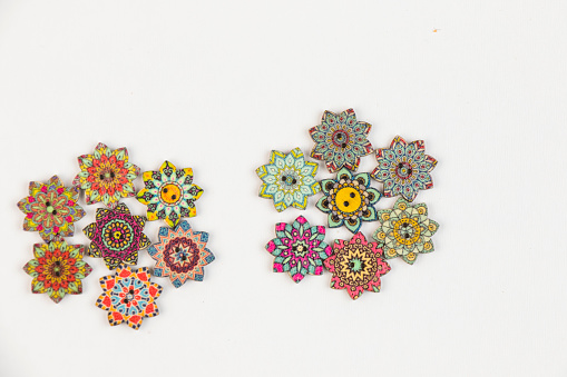 Colorful ornamental button on the white background, backdrop