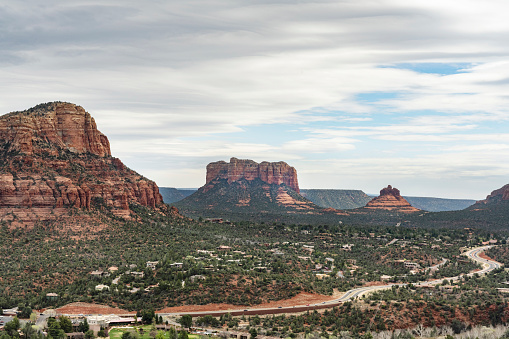 This is a high angle photograph of the scenic mountain landscape rising up above the town of Sedona, Arizona in spring time.
