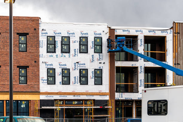 New home construction site in Colorado with sign on scaffolding for Tyvek homewrap for Market Place Lofts Apartment complex stock photo