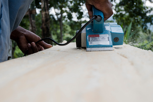 Carpenter is planning a wooden plank to make a garden hut