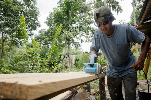Carpenter is planning a wooden plank to make a garden hut