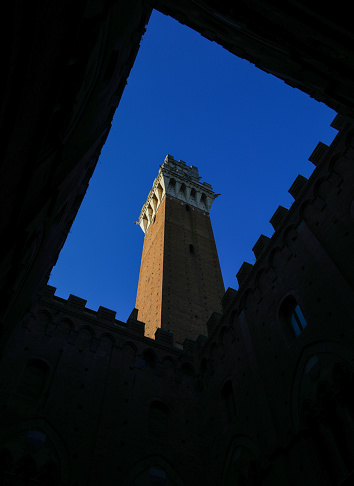 Siena, SI, Italy - February 20, 2023: famous tower called DEL MANGIA from the courtyard of the town hall