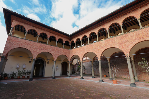 Siena, SI, Italy - February 20, 2023: Ancient cloister of the convent of the Basilica of San Domenico