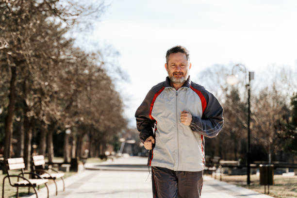 istock Middle aged athlete running in the park 1468572390