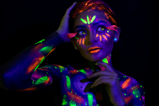 Woman modelling neon bodypaint and pupils