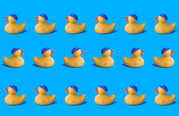istock Yellow toy duckling for bathing on the blue background. Pattern. Flat lay. 1468572738