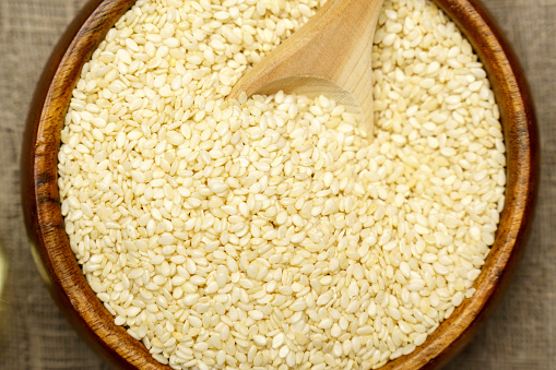 White sesame seeds, sesame seeds on an old rustic background close-up. Selective focus