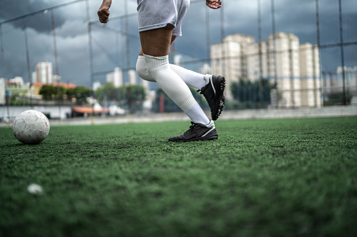 Low section of a female soccer player playing soccer