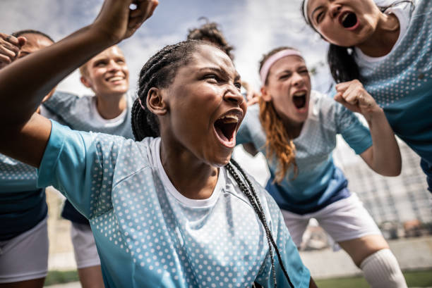istock Happy female soccer team celebrating 1468573684