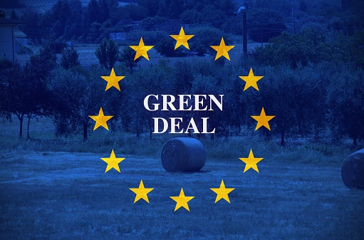 Land with the European flag as background with the sign green deal
