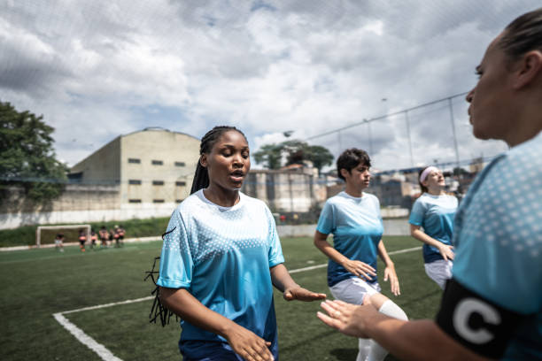 istock Female soccer team doing warm up exercise before match 1468573839