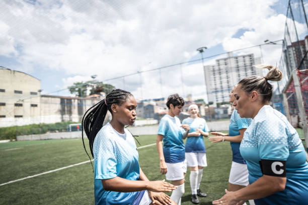 istock Female soccer team doing warm up exercise before match 1468573850