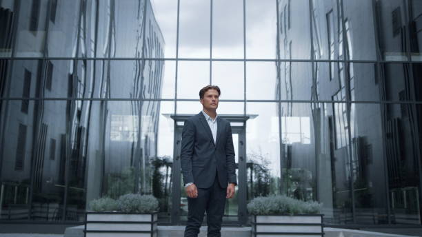 istock Serious businessman standing outdoors inspect downtown district. Success concept 1468573886