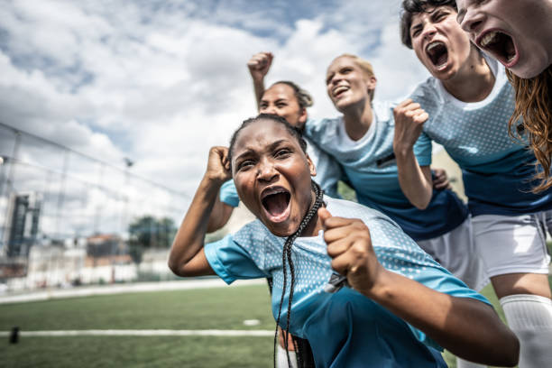 istock Happy female soccer team celebrating 1468573988