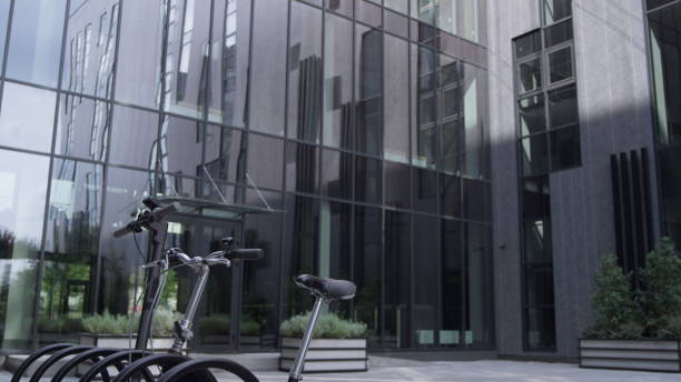 istock Shared vehicles standing on parking lot at modern glass office building morning 1468575908
