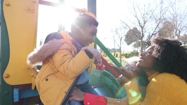grandmother mom and grandson playing in the slide park - single mother, african american family -