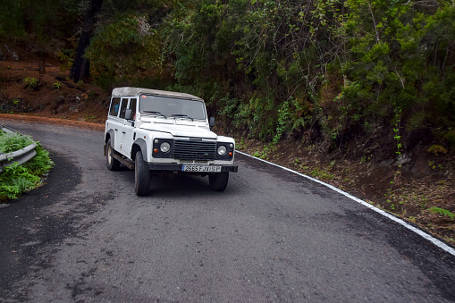 Santa Catalina, Spain - 24th October, 2014: Land Rover Defender driving on a road in the jungle scenery. This vehicle is used to get in extremely hard areas.