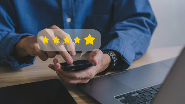 istock close up on customer man hand pressing on smartphone screen with gold five star rating feedback icon and press level excellent rank for giving best score point to review the service , business concept 1468583507