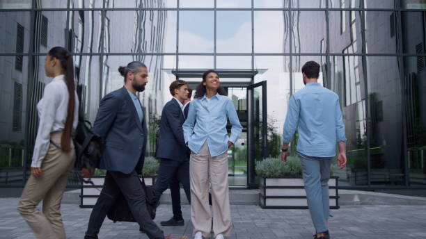 istock Smiling business lady standing feeling confident outdoors modern glass building. 1468583522