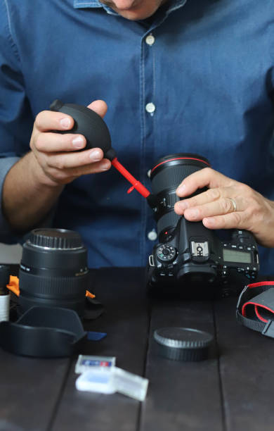 istock Cleaning glasses lens with a brush. 1468584010