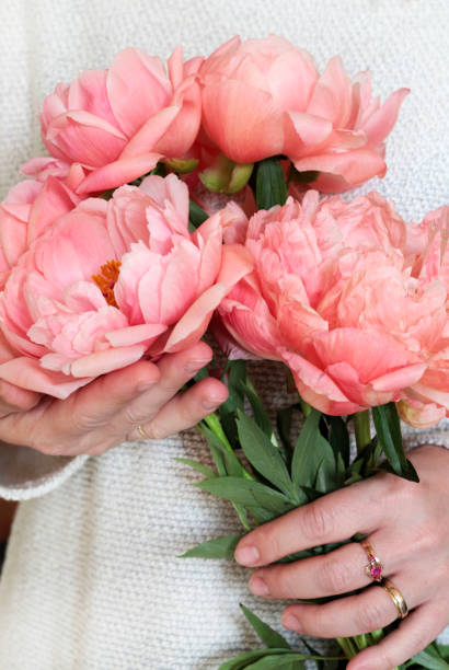 istock Woman holding pink flowers. 1468584066