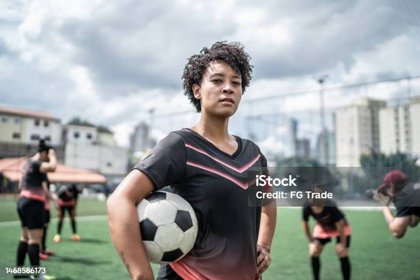 Portrait Of A Female Soccer Player Holding A Soccer Ball In The Field Stock Photo - Download Image Now