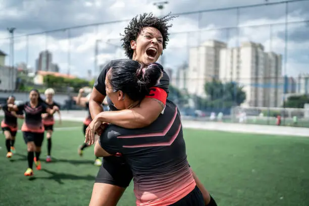 Female soccer team celebrating