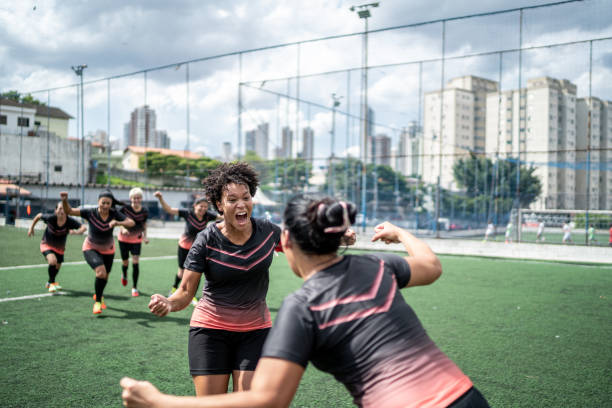 istock Female soccer team celebrating 1468586388